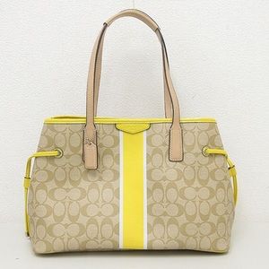 Yellow and tan leather coach logo purse tote